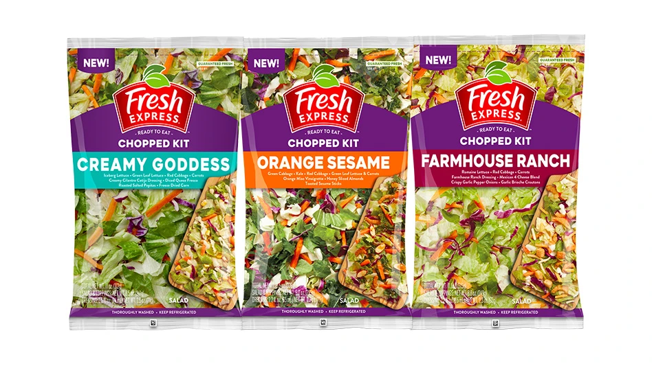 Three purple bags of salad kits.