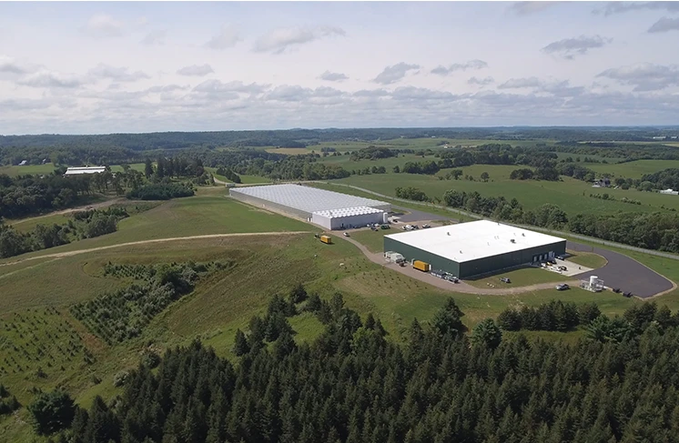 Aerial shot of plains and a greenhouse